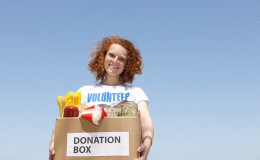Volunteer carrying food donation box