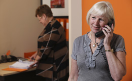 Wendy Uttley talking to a client on the phone